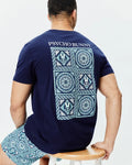 Mens Frank Back Graphic Tee, a relaxed fit navy blue jersey t-shirt with a large back graphic featuring a light blue, teal, and white mosaic tile pattern, incorporating Psycho Bunny skull logos and Psycho Bunny text.
