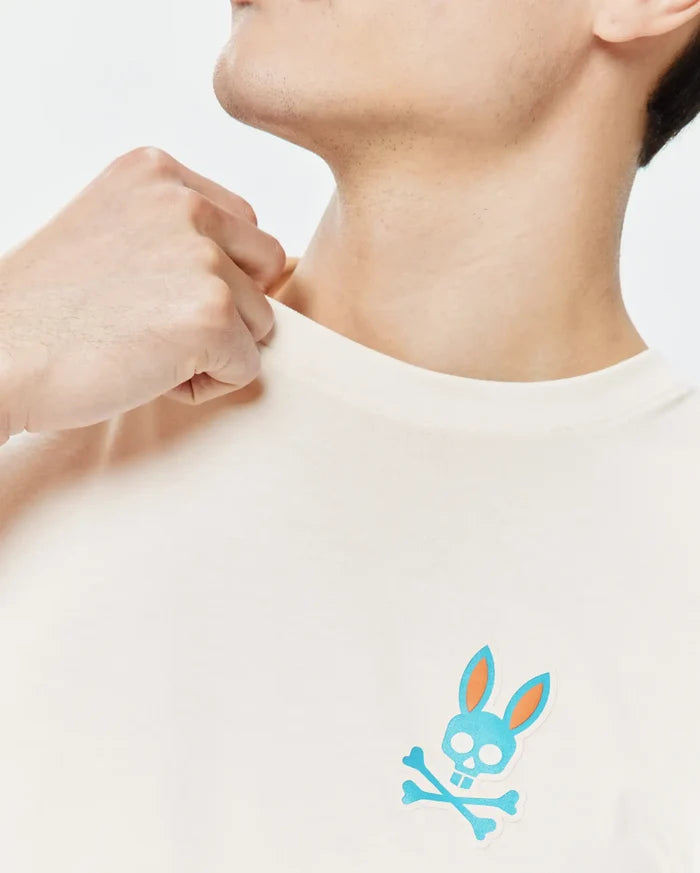 Cream Mens Frank Back Graphic Tee, classic fit, soft jersey knit, featuring a small embroidered blue and orange Psycho Bunny skull and crossbones logo on the left chest.
