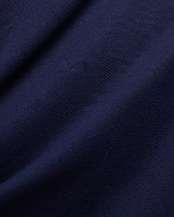 Rich, premium dark blue jersey fabric, subtly textured with soft folds, embodying the refined streetwear aesthetic of the Mens Frank Back Graphic Tee by Psycho Bunny.