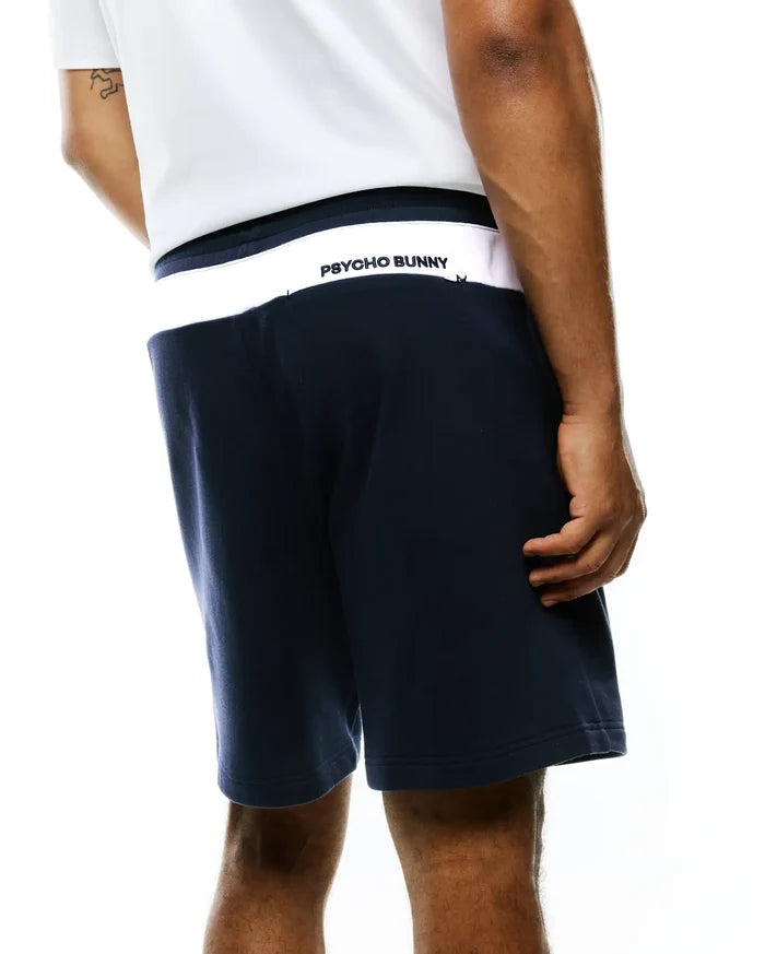 Mens Gabe French Terry Sweatshort, navy, relaxed fit, soft French terry fabric, with a white back waistband featuring a bold black Psycho Bunny text logo.