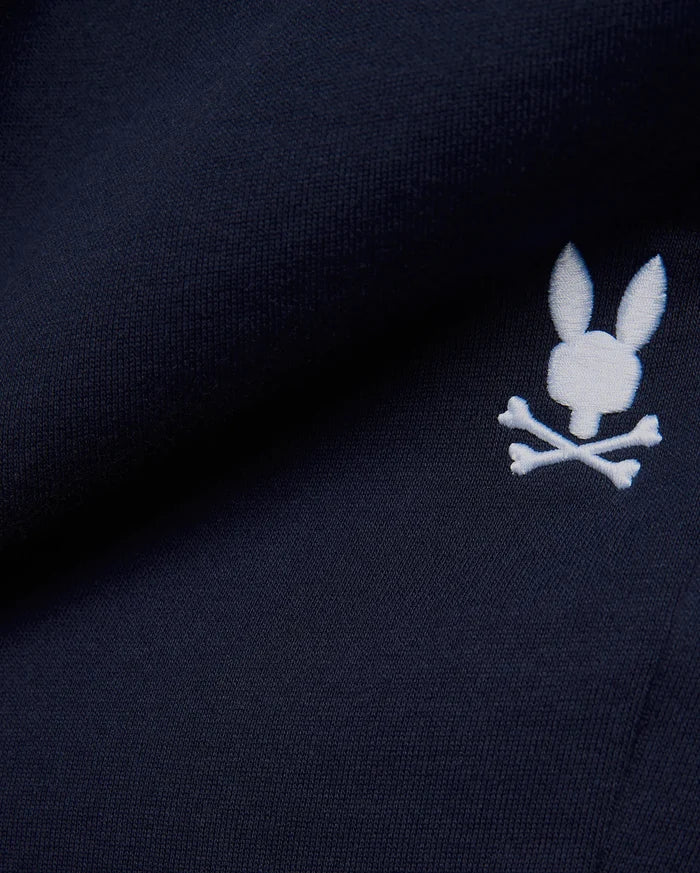 Premium deep navy blue MENS GABE FRENCH TERRY SWEATSHORT, showcasing a soft French terry knit texture and an iconic, crisp white embroidered Psycho Bunny skull logo, embodying refined streetwear style.