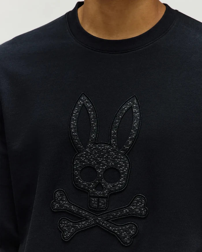 Mens Gabin Textured Crew, a black classic-fit sweatshirt featuring a large, tonal black embroidered and textured Psycho Bunny skull logo prominently on the chest, crafted from soft jersey.