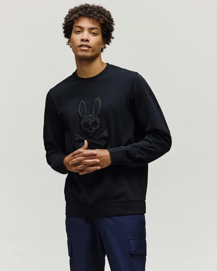 Black Mens Gabin Textured Crew sweatshirt, a classic fit crafted from textured black fabric, featuring a large, raised Psycho Bunny skull and crossbones logo on the chest.