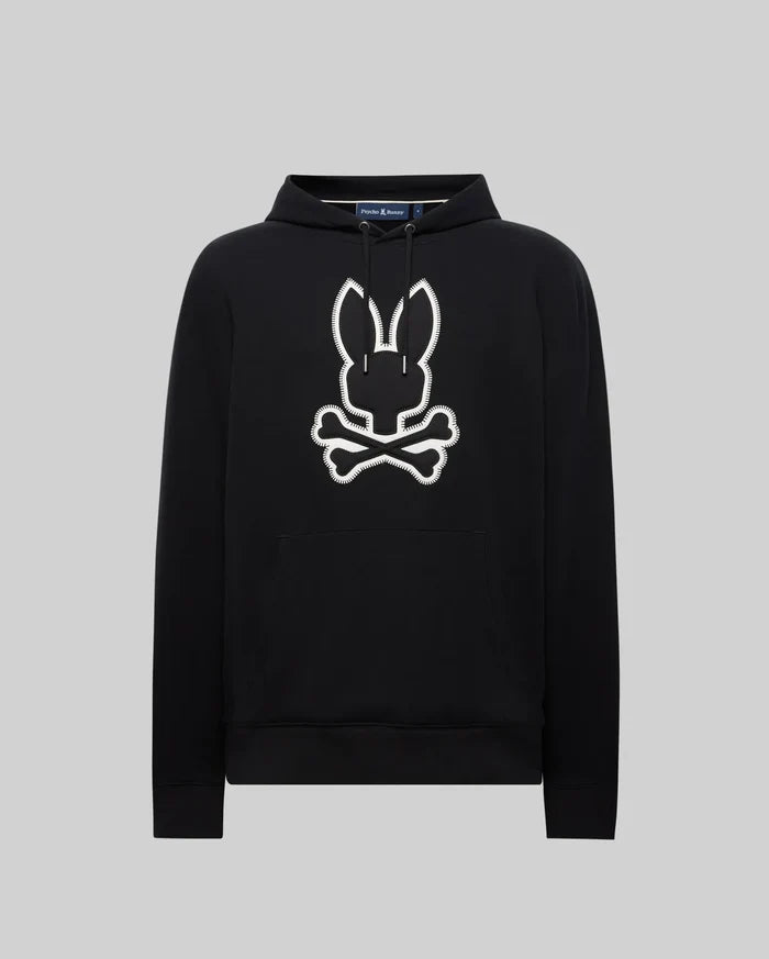 Black Mens Gage Patch Hoodie, relaxed fit, soft cotton blend. Large white embroidered Psycho Bunny skull and crossbones patch with zig-zag stitching on the center chest, plus a front kangaroo pocket.