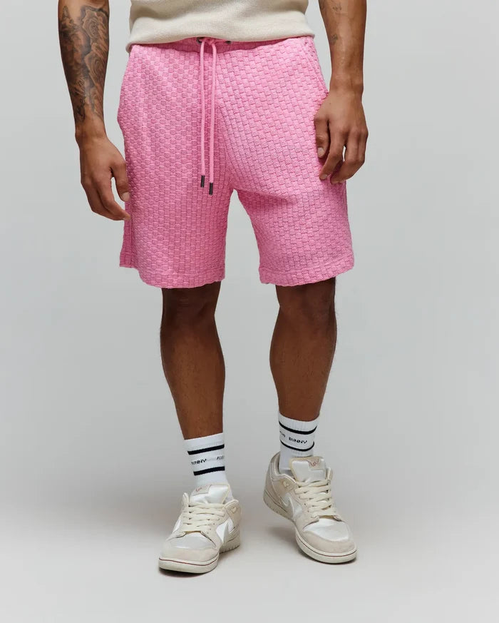 Mens Garen Knit Short in vibrant pink, featuring a textured woven knit pattern, relaxed fit, and a drawstring waist with dark metal tips.