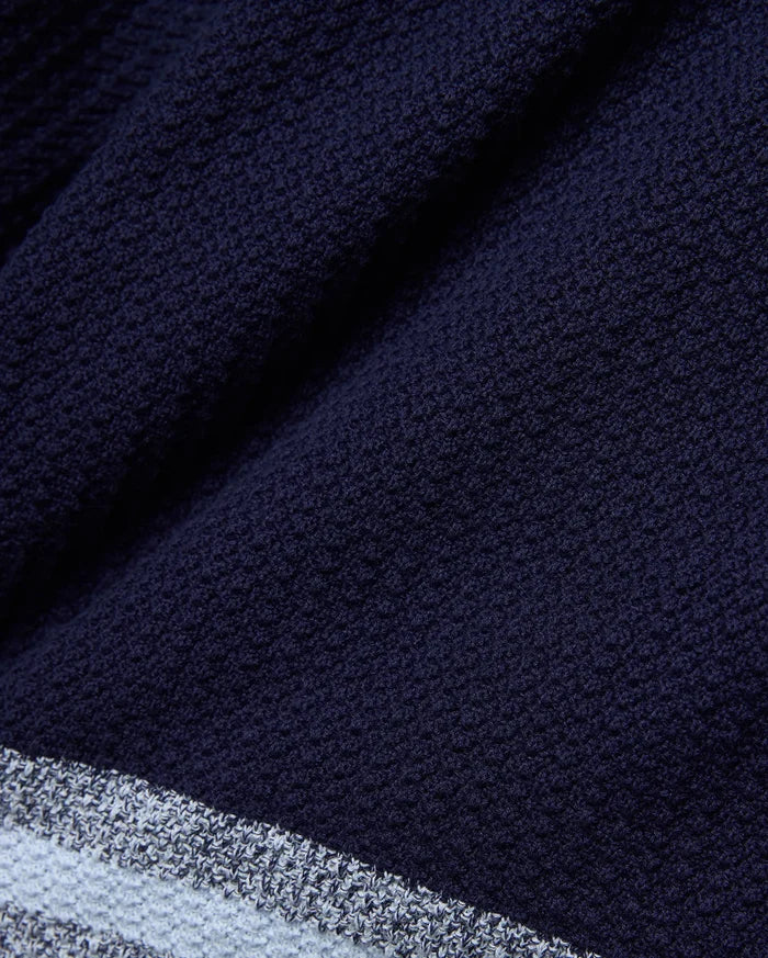 Mens Giles Knit Short 7, crafted from a deep navy textured knit fabric, detailed with a contrasting light blue and white striped hem for a refined streetwear aesthetic.
