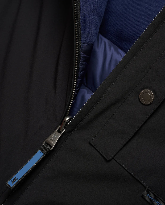 Mens Gordler Reversible Vest, black smooth woven outer, reversible to navy blue quilted interior with ribbed collar. Features a full zip with Psycho Bunny skull logo pull, branded snap, and Psycho Bunny text tag.