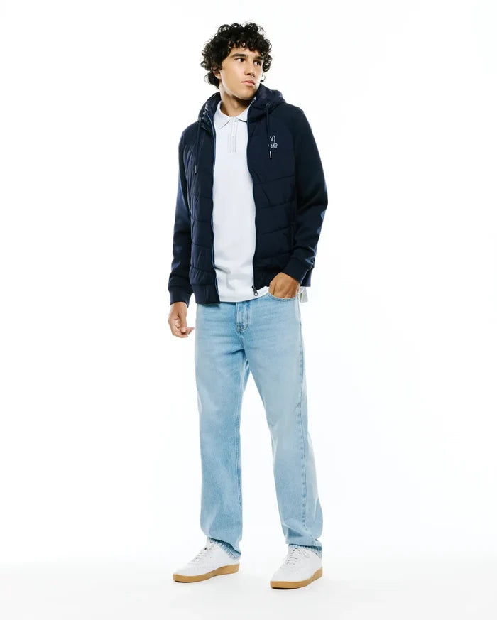 Mens Gordley Mix Media Jacket: Navy blue hooded full-zip jacket featuring a quilted puffer body, smooth sleeves, and a small white embroidered Psycho Bunny skull logo on the left chest.