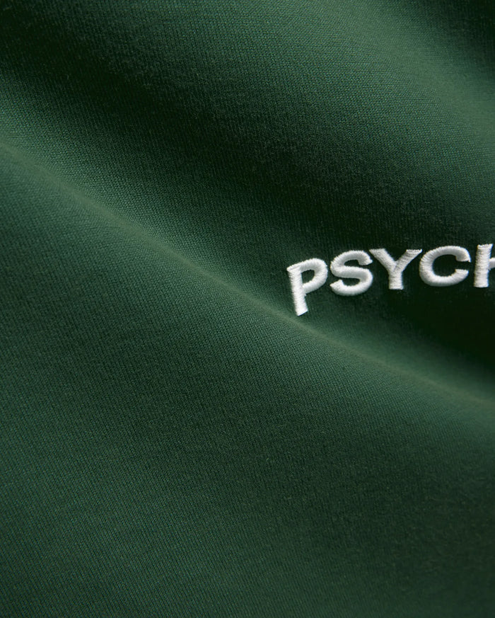 Mens Haiden Relaxed Heavy Weight Tee in dark green, featuring a heavyweight jersey knit texture and a prominent embroidered white Psycho Bunny PSYCH text logo.