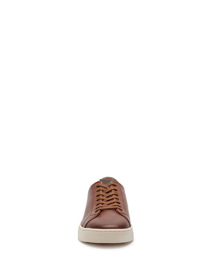 A single Vince Camuto Men’s Hallman Casual Sneaker is centered on a white background and shown from the front, featuring brown leather construction, tan laces, and a white sole—an excellent example of how Vince Camuto redefines comfortable footwear with beautiful design.