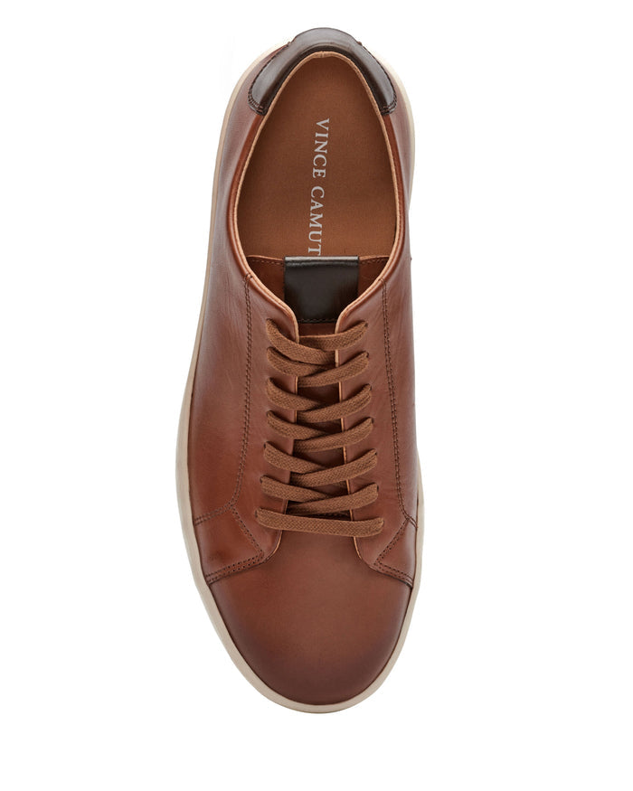 A top view of the Vince Camuto Men’s Hallman Casual Sneaker showcases its rich brown leather upper, matching brown laces, crisp white sole, and distinctive Vince Camuto branding on the insole near the heel—these comfortable essentials effortlessly combine style and comfort.