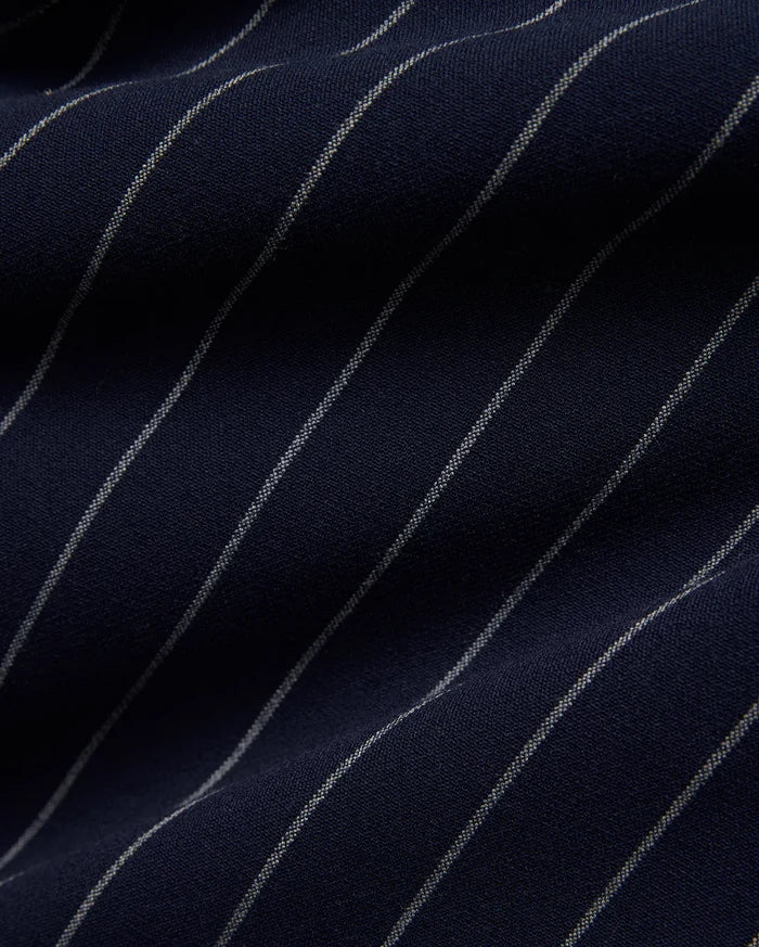 Mens Harland Double Weave Chalk Stripe Track Pant in deep navy blue, featuring fine, textured white chalk stripes woven into the fabric, highlighting its premium double weave texture.