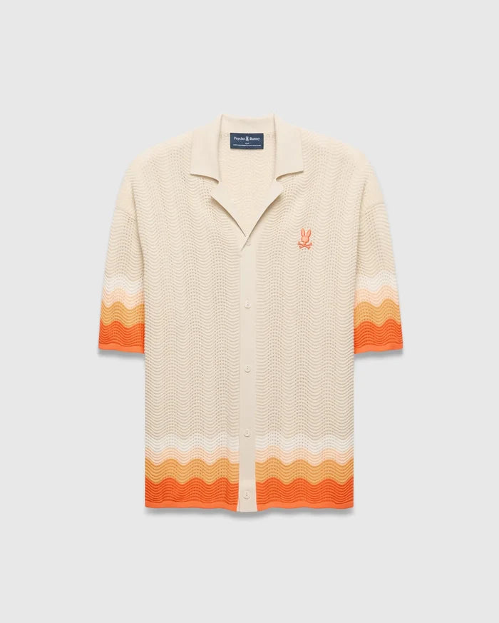 Cream Mens Holden Relaxed Fit Knit Shirt with a wavy texture, featuring an orange and peach ombre stripe on the sleeves and hem, and an embroidered orange Psycho Bunny skull logo on the left chest.