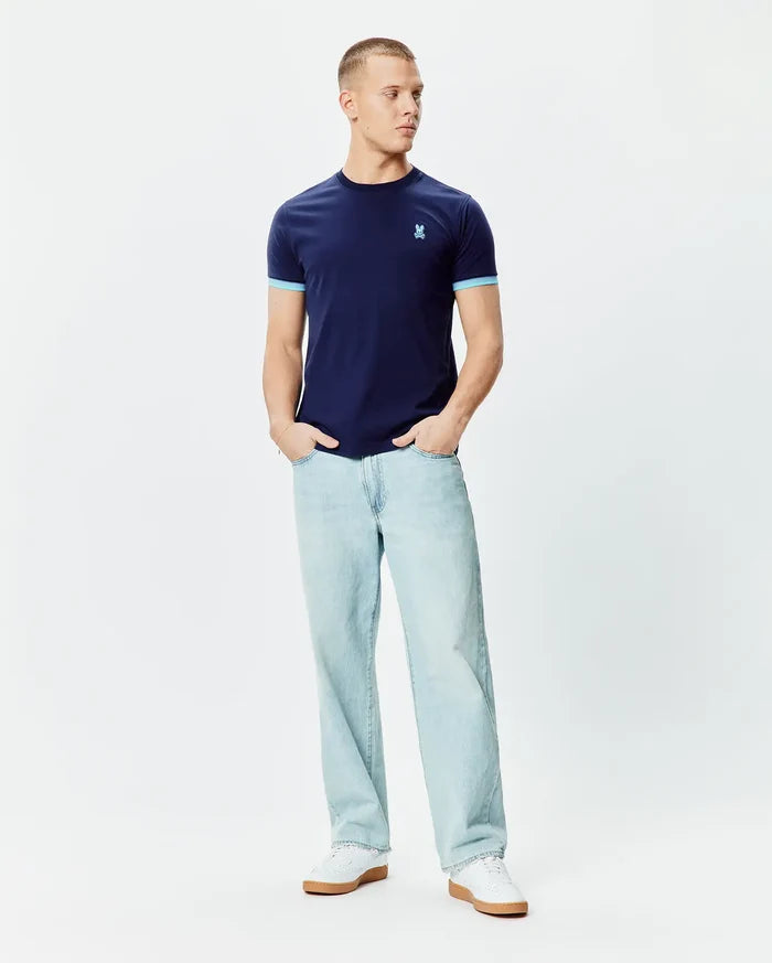 Mens Holden Tee, navy blue jersey t-shirt with light blue contrast ribbed cuffs and a small embroidered Psycho Bunny skull logo on the left chest, classic fit.