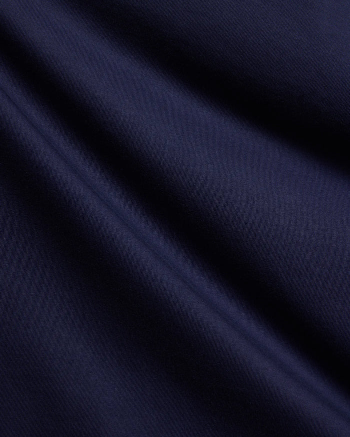 Mens Holden Tee, a premium deep navy blue jersey knit fabric, showcasing its smooth, soft texture and subtle, elegant folds, perfect for refined streetwear style.