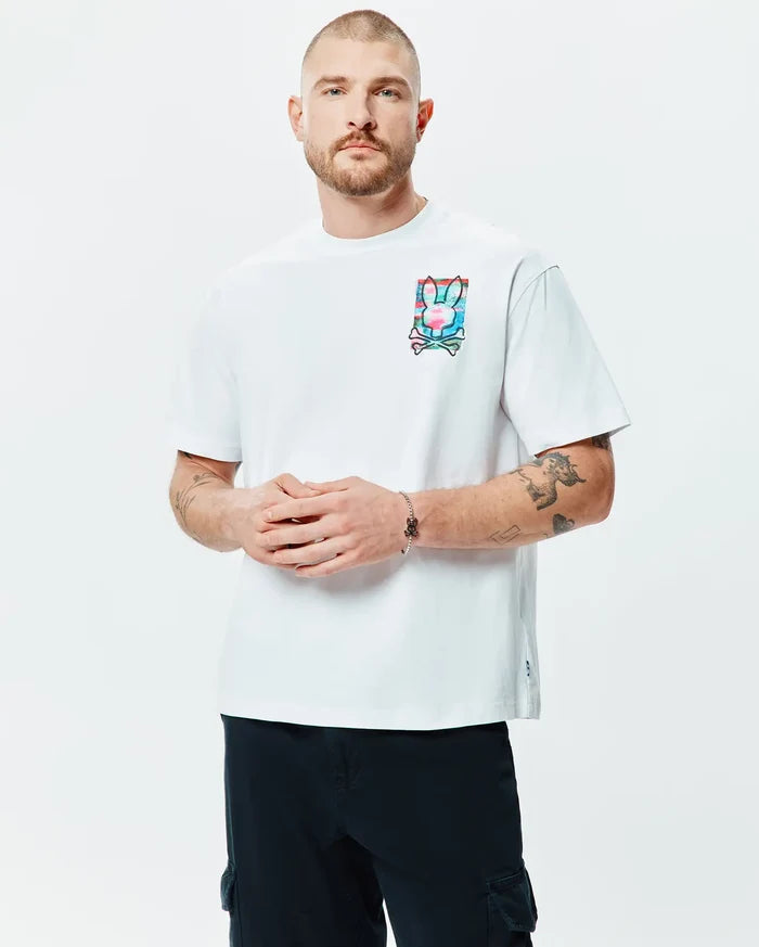 White Mens Isaac Relaxed Fit Tee, crafted from soft jersey, features a prominent multi-color Psycho Bunny skull logo graphic print on the left chest.