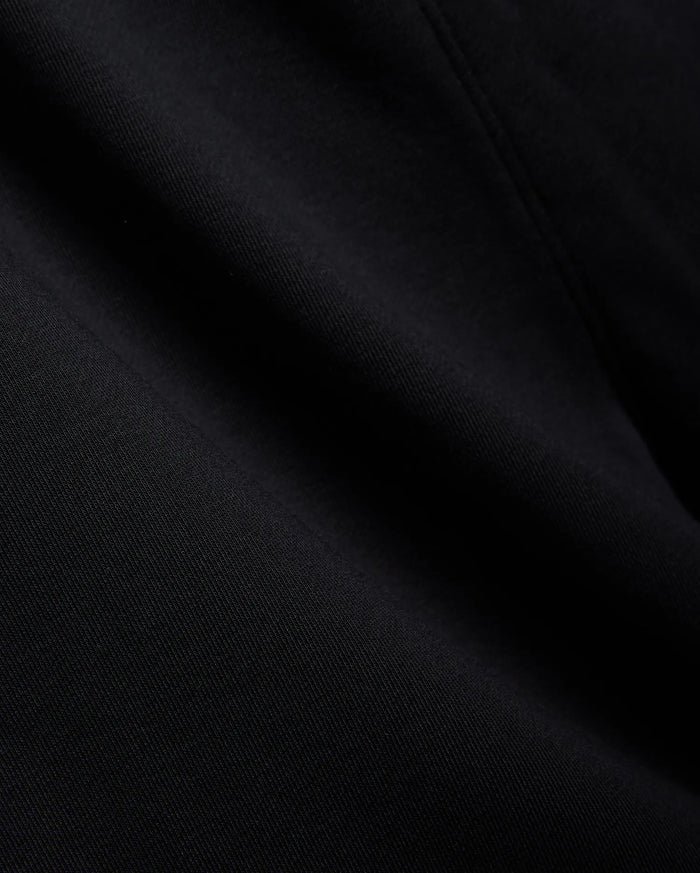 Mens Isaac Print Short in deep black, showcasing a premium, soft jersey knit fabric with a subtle, refined texture and gentle folds, embodying Psycho Bunny's quality.