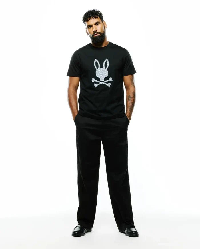 Mens Jaden Appliqué Graphic Tee, a black classic fit jersey t-shirt with a large white Psycho Bunny skull logo featuring an internal cross pattern, centered on the chest.