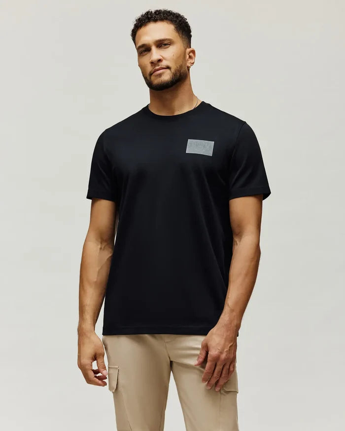 Mens Jarvis Chest Graphic Tee, a classic fit black jersey knit t-shirt with a subtle, tonal grey rectangular Psycho Bunny logo graphic on the left chest.