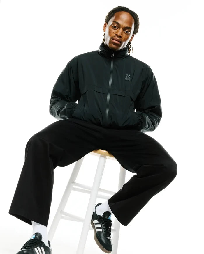 Mens Javier Nylon Windbreaker Jacket, black, relaxed fit, smooth nylon, full zip, stand collar, elasticized cuffs and hem, with a tonal embroidered Psycho Bunny skull logo on the left chest.