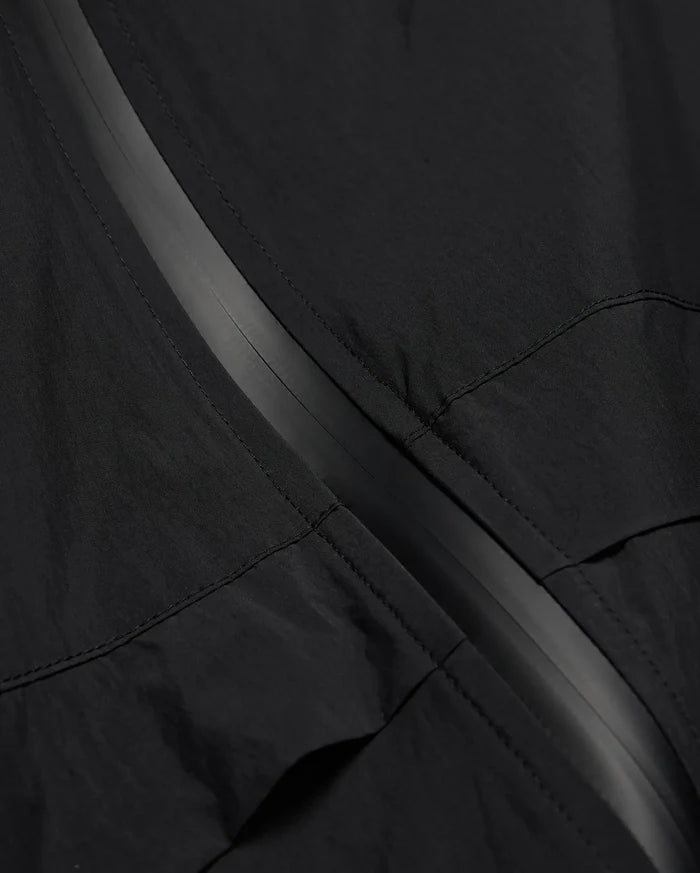 MENS JAVIER WINDBREAKER JACKET in black, featuring a subtle dark grey central zipper strip and visible panel stitching on lightweight, crinkled fabric.