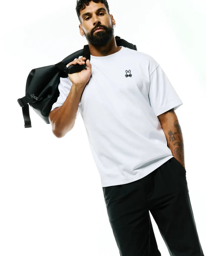 Mens Jaydon Pima Cotton Oversized-Fit Tee in crisp white, featuring a smooth jersey texture and a small, embroidered black Psycho Bunny skull logo on the left chest.