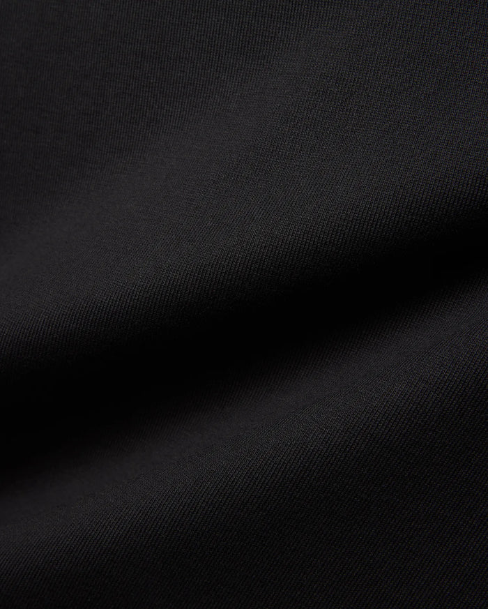 Mens Jaydon Relaxed Fit Tee in deep black, crafted from a premium, soft-touch jersey knit fabric with a subtle, refined texture, embodying Psycho Bunny's signature comfortable streetwear aesthetic.