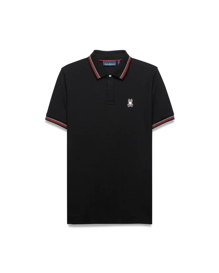 Mens Jaydon Pique Polo, classic fit, black pique fabric with red and white striped collar and cuffs, featuring a small embroidered Psycho Bunny skull logo on the left chest.
