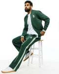 Dark green Mens Jaydon Track Pant, relaxed fit, smooth knit, with light green side stripes and a small embroidered white Psycho Bunny skull logo on the left thigh, paired with a matching bomber jacket.