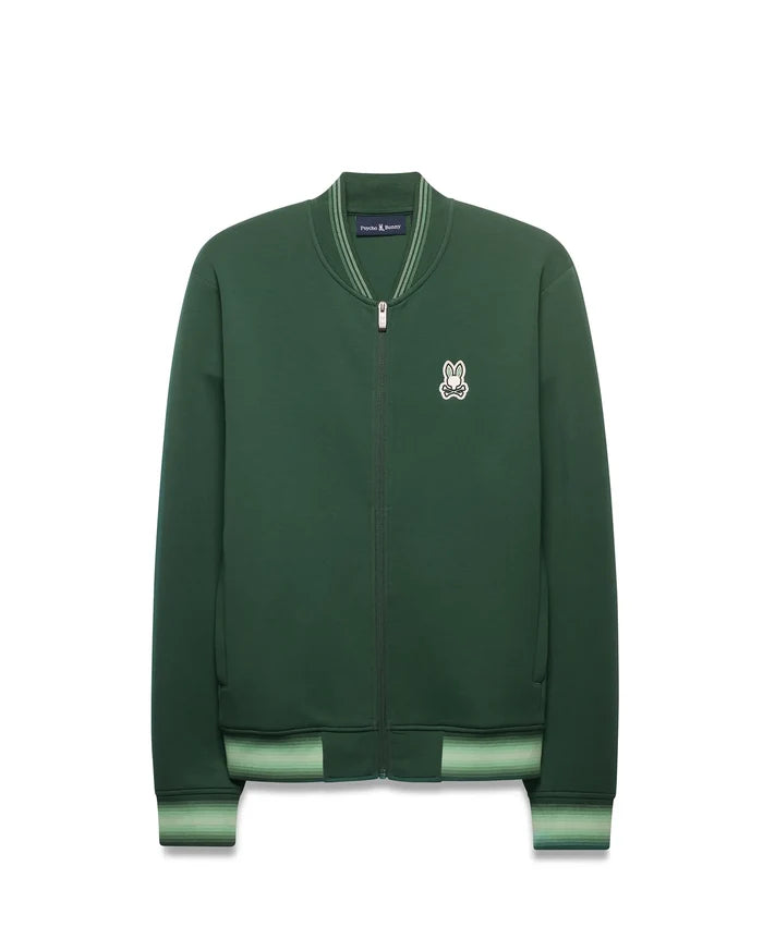 Mens Jaydon Track Jacket in forest green, featuring a full-zip closure, classic fit, smooth knit fabric, and a small embroidered white Psycho Bunny skull logo on the left chest. Ribbed collar and cuffs have light green stripes.