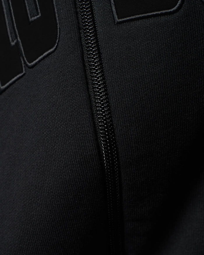 Mens Joaquin Mix Media Reversible Bomber in black, showcasing large raised black letters with a subtle grey outline on a smooth knit fabric, alongside a black front zipper.