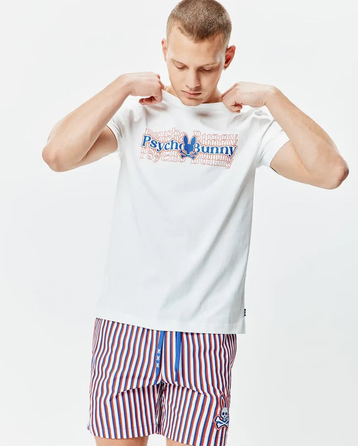 Mens John Back Graphic Tee, a white jersey t-shirt with a large layered red and blue Psycho Bunny chest graphic, paired with red, white, and blue striped shorts featuring a small embroidered bunny skull logo.