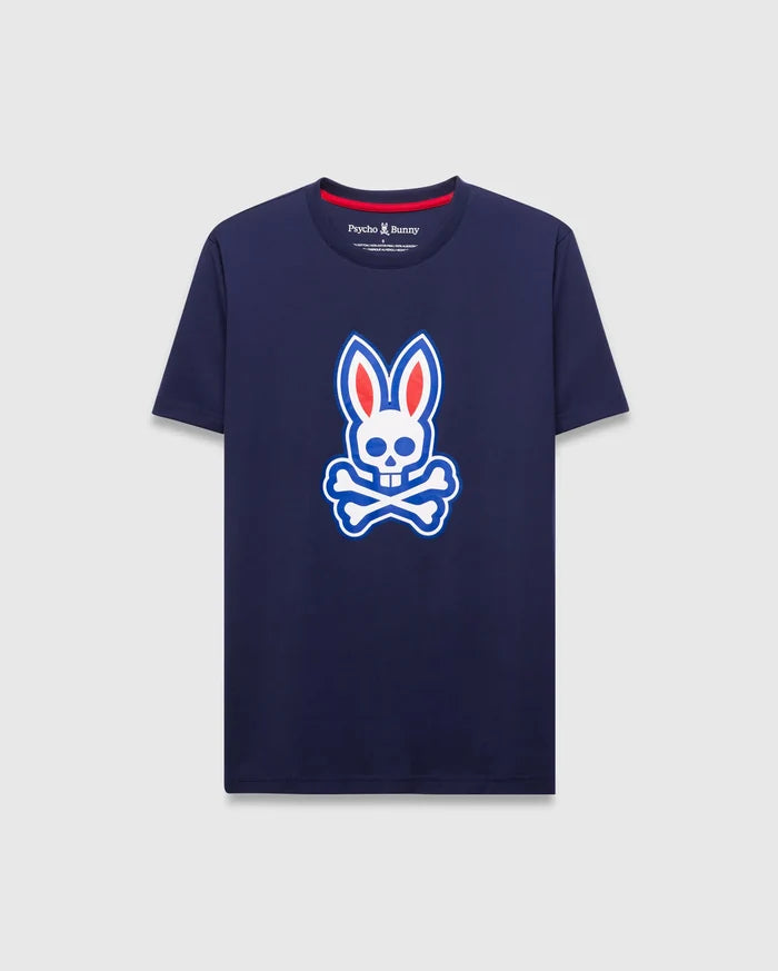 Mens John Graphic Tee, a classic fit navy jersey t-shirt featuring a large white, red, and blue Psycho Bunny skull logo graphic on the center chest and red neck tape.