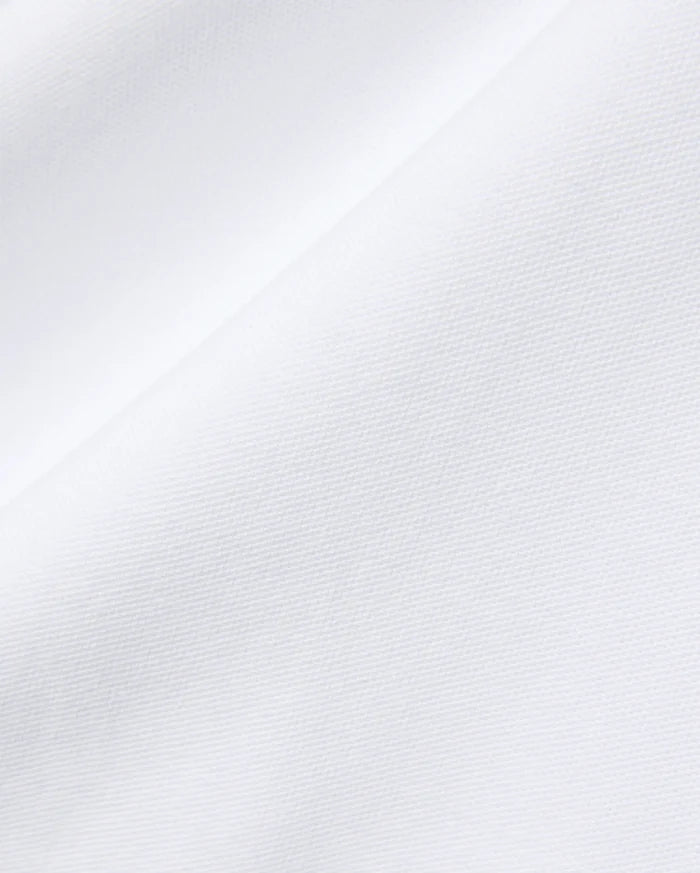Mens John Pique Polo in crisp white, crafted from breathable pique fabric, featuring the signature embroidered Psycho Bunny skull logo on the chest for a refined streetwear look.