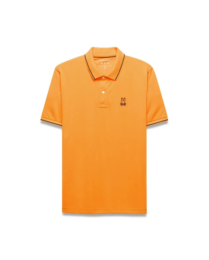 Mens Joji Performance Polo in vibrant orange, featuring a classic fit, smooth jersey fabric, black tipping on the collar and cuffs, and a small embroidered Psycho Bunny skull logo on the left chest.