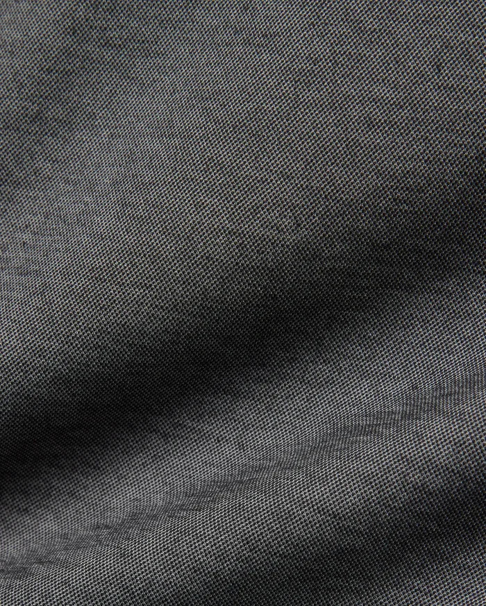 Psycho Bunny MENS JOJI PERFORMANCE POLO in a deep charcoal grey, featuring a premium, subtly textured pique knit fabric, offering a refined streetwear aesthetic and classic fit.
