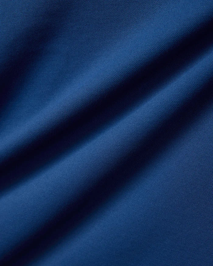 Psycho Bunny Mens Joji Performance Polo in deep blue, featuring a finely textured pique knit fabric, embodying refined streetwear style.