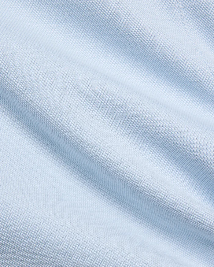 Mens Keith Short 8, showcasing a close-up of its premium light blue pique knit fabric, featuring a subtle, breathable texture, embodying Psycho Bunny's refined streetwear aesthetic.