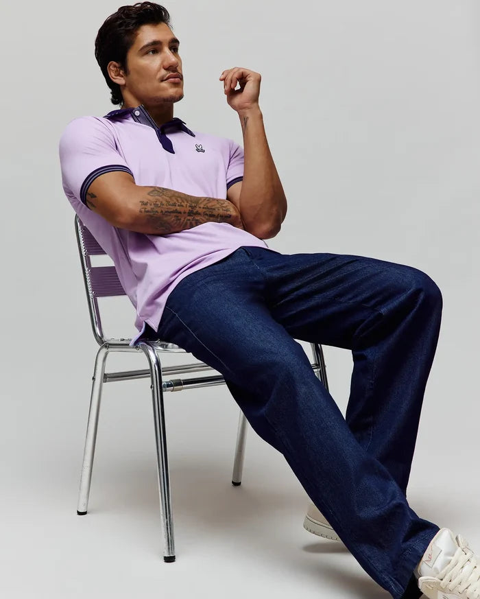 Mens Kenyon Lightweight Pique Polo in lavender, classic fit, with navy collar and striped cuffs, featuring a small embroidered Psycho Bunny skull logo on the left chest.