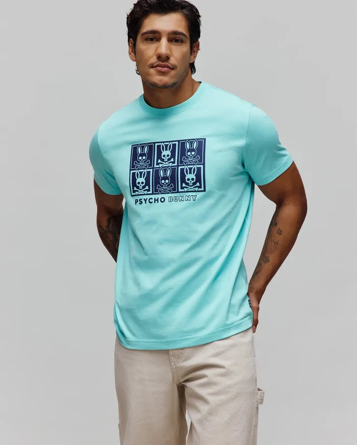 Mens Keon Graphic Tee, a classic fit aqua jersey t-shirt featuring a large dark blue chest graphic of six Psycho Bunny skull logos in a grid with Psycho Bunny text.