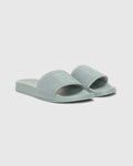 The Psycho Bunny MENS KNIT SLIDES - B6A474F200 are light green sandals with textured wide straps and an ergonomically molded footbed for comfort, shown on a plain white background.