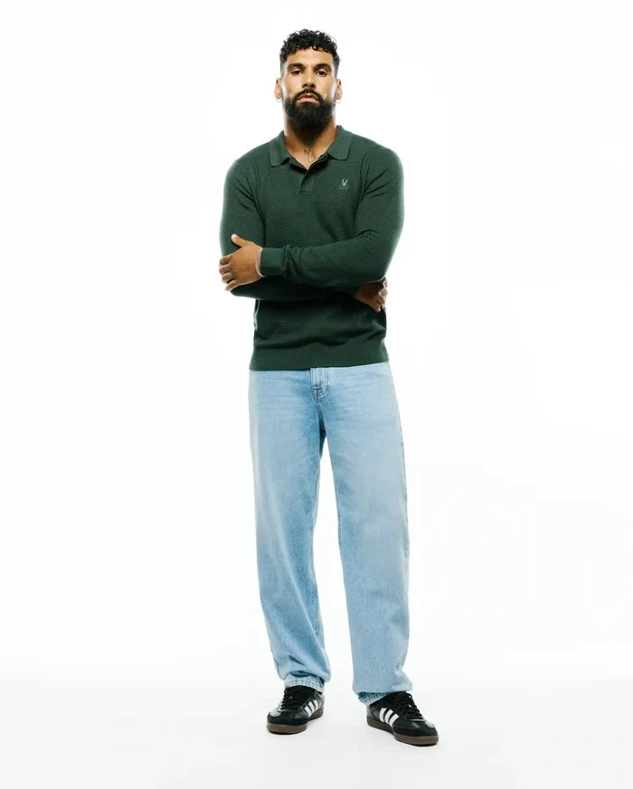 Mens Leroy Long Sleeve Knit Polo in deep forest green, featuring a classic fit, textured knit fabric, and a small white embroidered Psycho Bunny skull logo on the left chest.