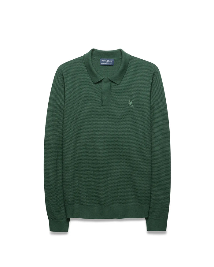 Mens Leroy Long Sleeve Knit Polo in dark green, featuring a textured knit fabric, classic fit, two-button placket, and small embroidered Psycho Bunny skull logo on the left chest.