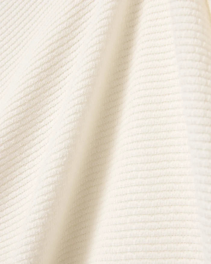 Mens Leroy Long Sleeve Knit Polo in a luxurious cream hue, showcasing a refined, soft-touch ribbed knit texture, embodying Psycho Bunny's premium streetwear aesthetic.