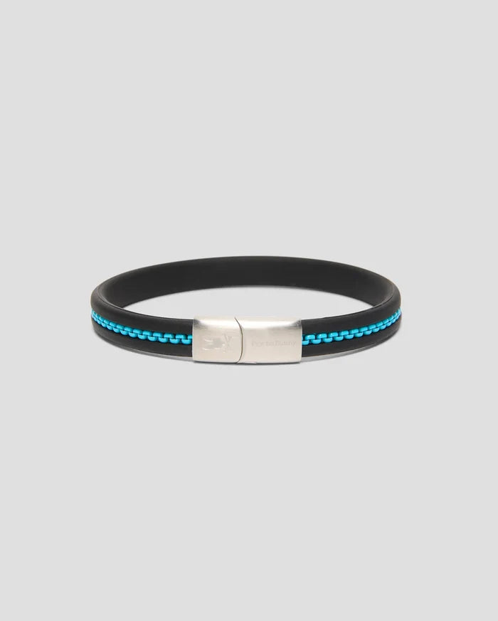 Mens Link Rubber Bracelet, a sleek black rubber band with a vibrant turquoise chain-link inlay and a polished silver clasp featuring engraved Psycho Bunny branding and skull logo.