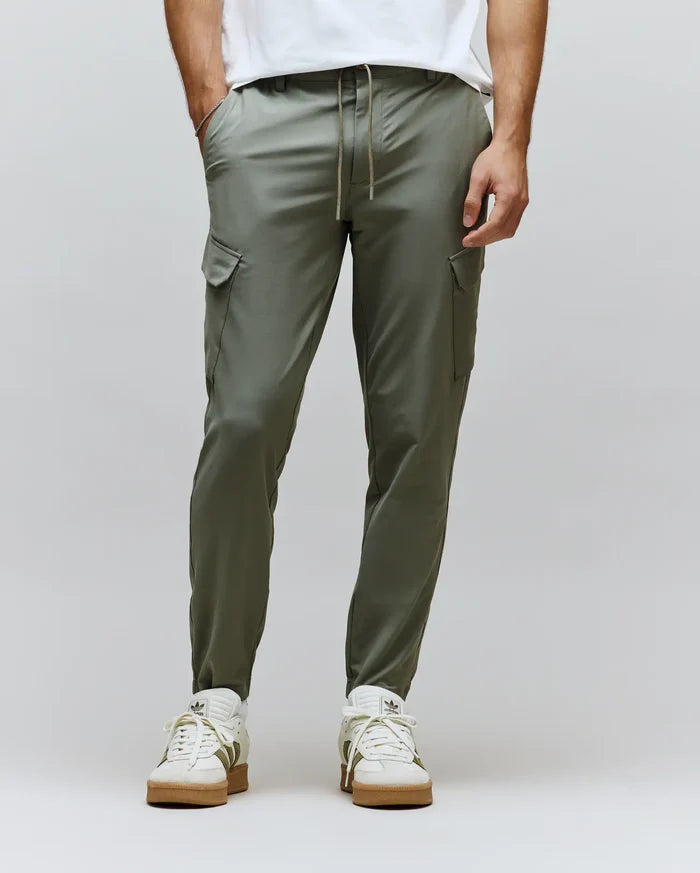 Mens Luka Cargo Pant in a modern slim fit, crafted from smooth olive green fabric, featuring practical side cargo pockets and an adjustable brown drawstring waist.