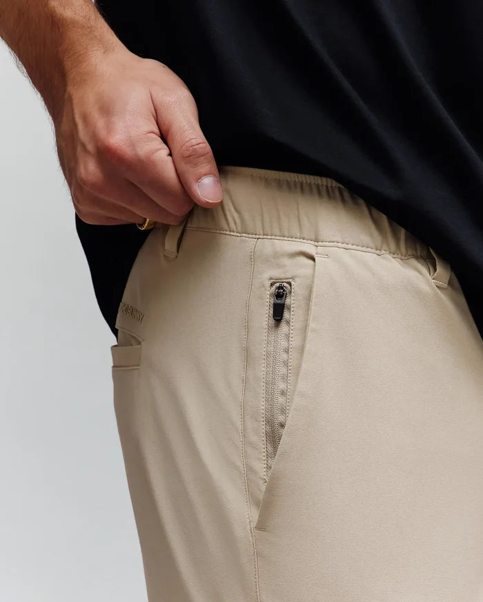 Mens Luka Cargo Pant, khaki, relaxed fit, smooth fabric, elasticated waistband, zippered side pocket with black pull, subtle embroidered Psycho Bunny text on back pocket.