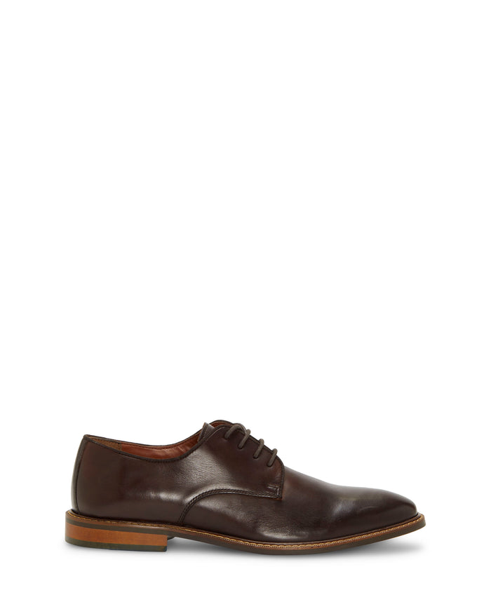 The Vince Camuto Men’s Lyre Derby is a dark brown leather dress shoe for men, featuring laces and a light brown sole. Displayed in a side profile on a plain white background, this classic shoe offers timeless style for any occasion.