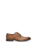 The Vince Camuto Men’s Lyre Derby is a classic brown leather dress shoe featuring black laces, a low heel, and a stitched sole for timeless style, shown against a white background.
