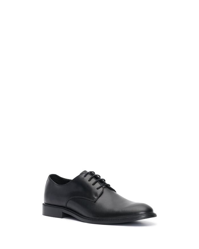 A single Vince Camuto Men’s Lyre Derby black leather dress shoe with laces, crafted from dark leather and displayed at an angle on a white background, showcasing its classic style.